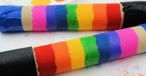 Rainbow colors painted onto a cardboard tube.