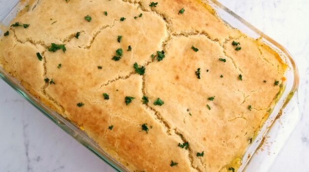Large glass dish with baked chicken pot pie casserole