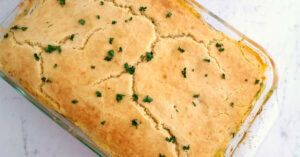 Large glass dish with baked chicken pot pie casserole.