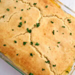 Close up of crust of chicken pot pie casserole in large glass baking dish