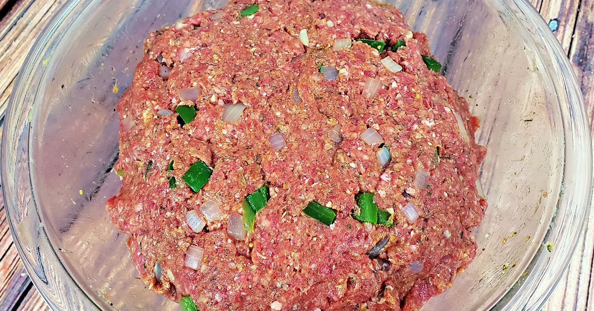 Gluten free meatloaf mixture well combined in glass mixing bowl.