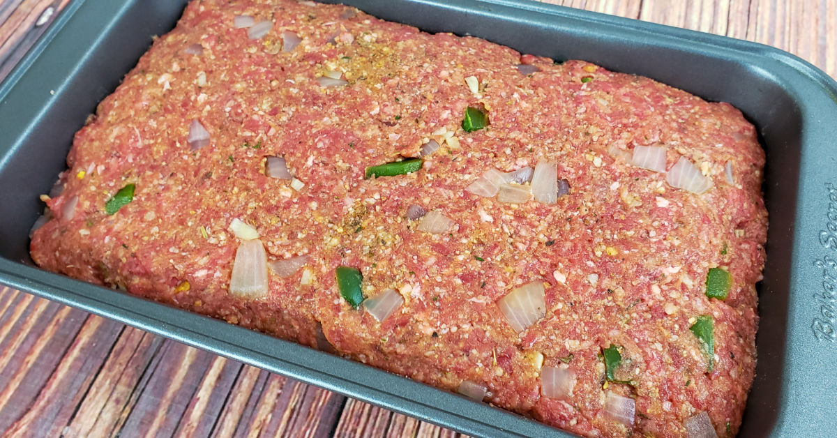 Gluten free meatloaf mixture pressed into loaf pan, ready to bake.