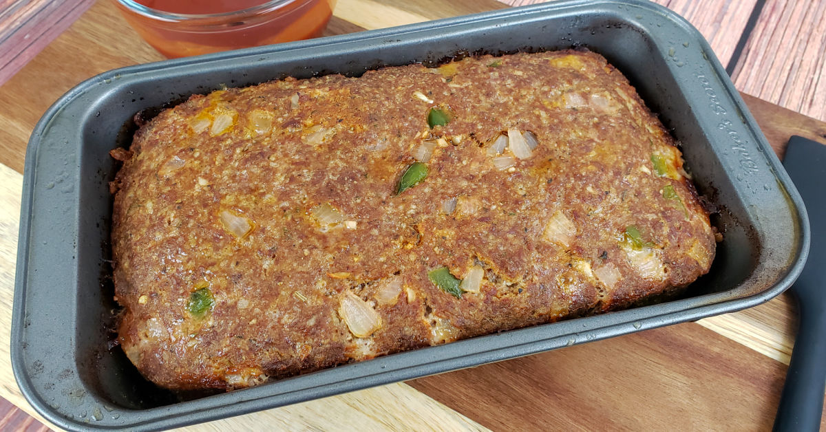 Gluten free meatloaf in loaf pan, half way through baking time.