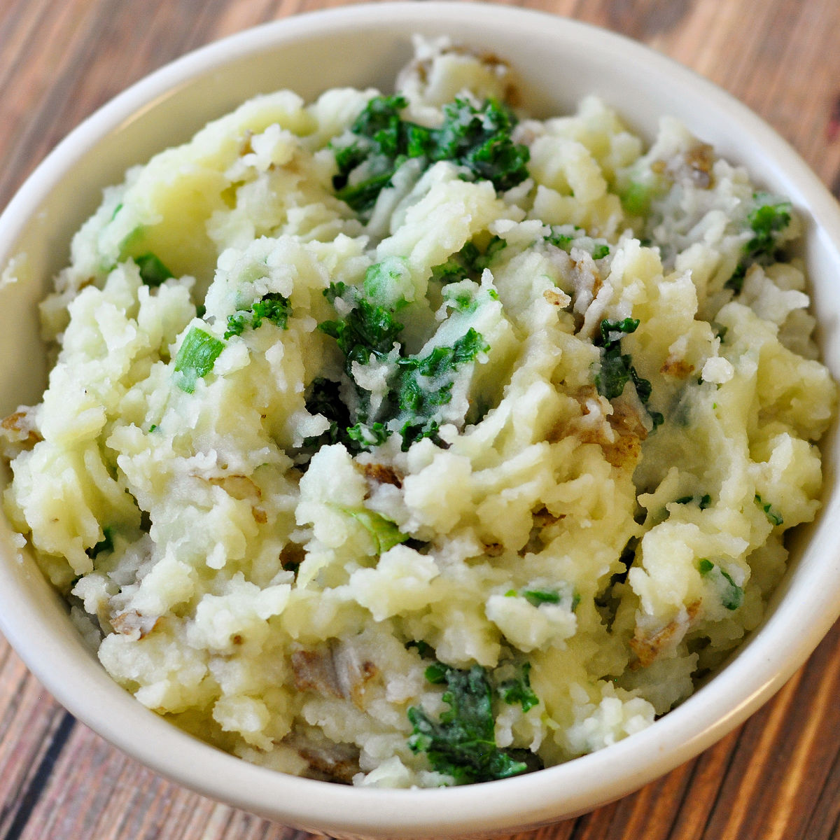 Close up of Irish Colcannon (mashed potatoes and kale) in a ceramic bowl