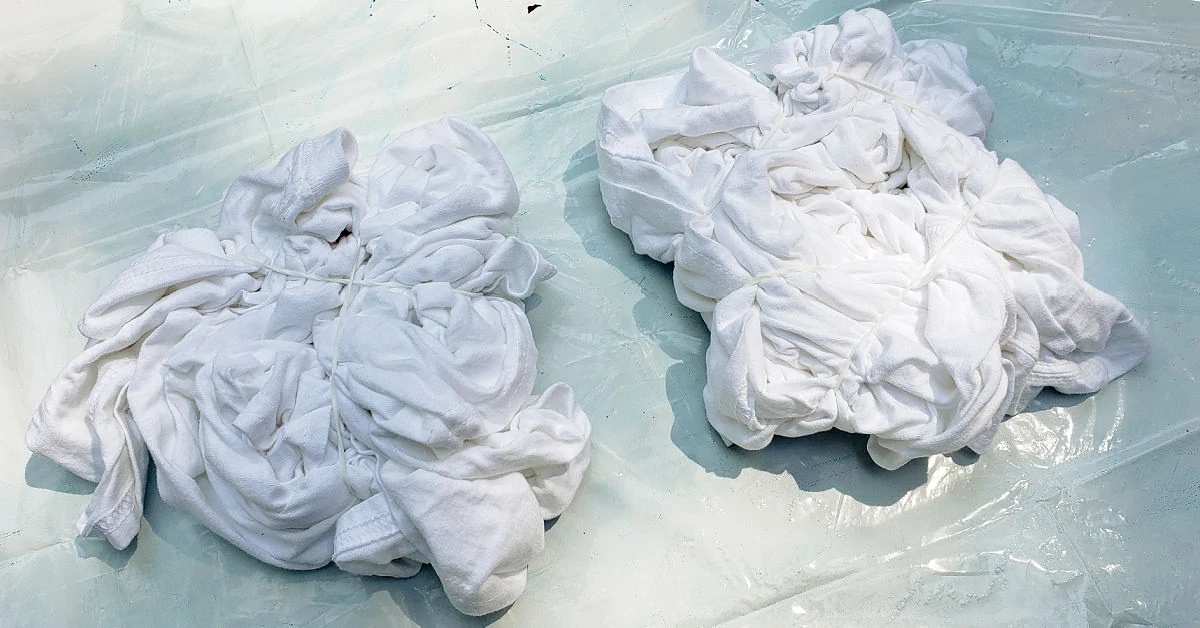 White t-shirts crumpled and ready to be dyed.