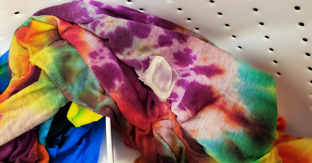 Freshly tie dyed shirts in washing machine.