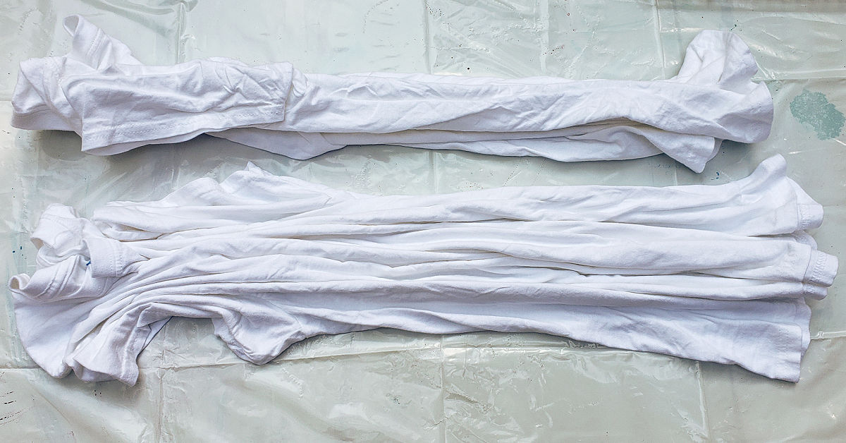 Two white shirts pleated lengthwise.