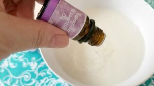 Adding lavender essential oil to bowl of melted soap base and almond oil