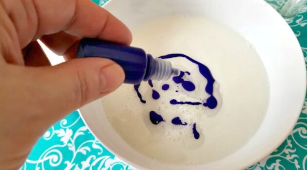 Adding soap colorant to soap and oil base in a bowl
