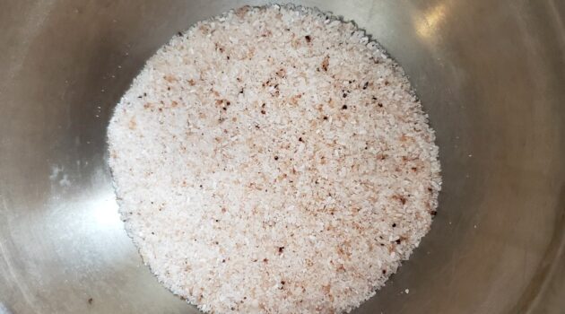 Fizzy bath salt ingredients in a silver metal mixing bowl shot from overhead
