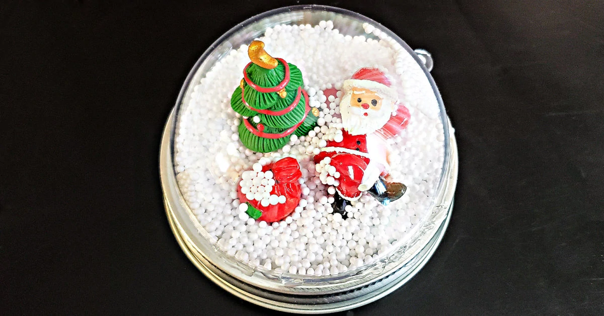 Snow Globe Mason Jar Ring Topper glued together and ready to attach to a jar.