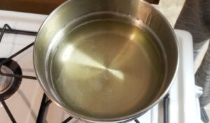 Melted glycerin soap in a double boiler on a pan