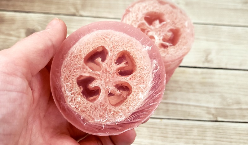 Loofah soaps popped out of silicone mold and in a hand