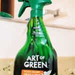 Art of Green multipurpose cleaner and green microfiber cleaning cloth on bathroom counter