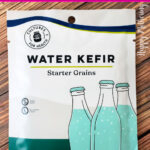 Packet of Cultures for Health Water Kefir Starter Grains laid on wood table.