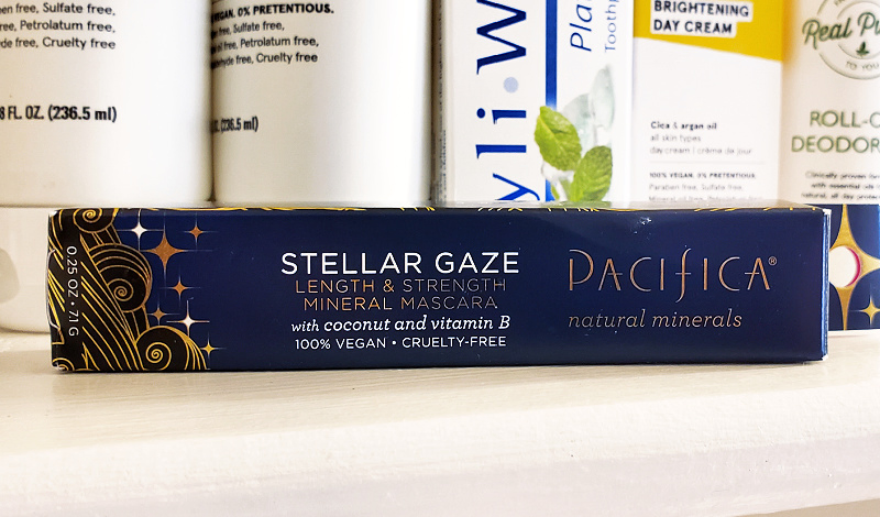 Pacifica Stellar Gaze Mascara on a white table in front of other personal care product bottles.