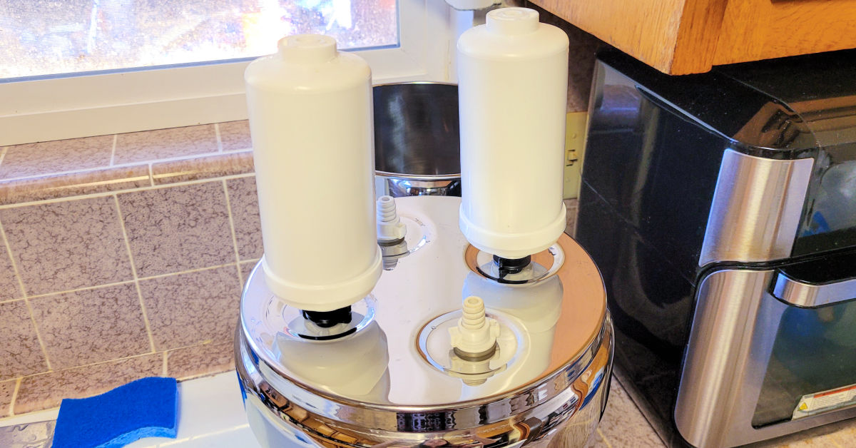 Two fluoride and arsenic filters being installed in a Royal Berkey Water Filter.