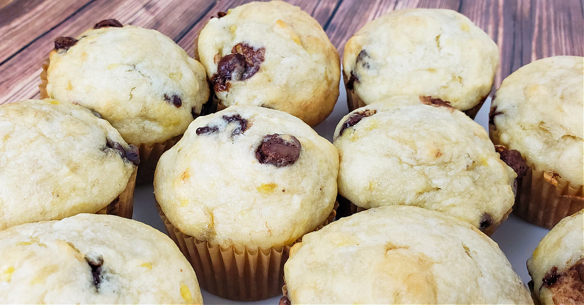 Several gluten free chocolate chip banana muffins arranged on a plate.