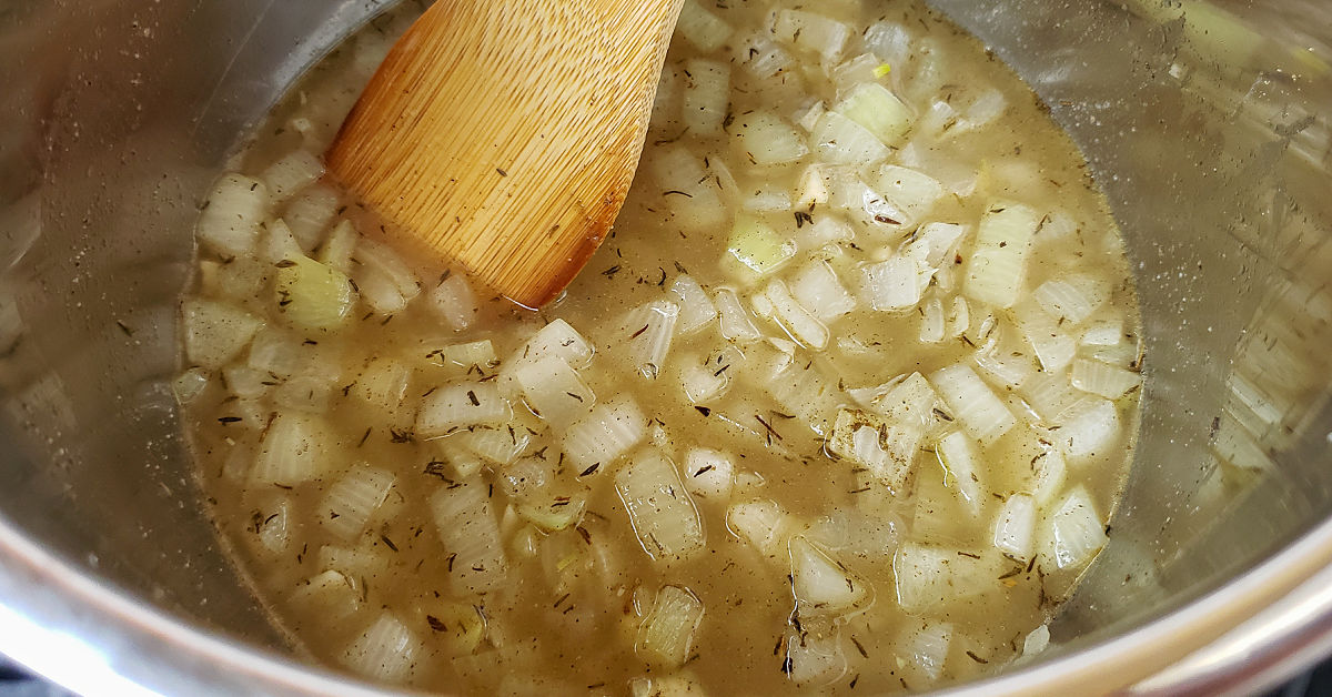 Chicken stock added to Instant Pot with onion, garlic and spices.