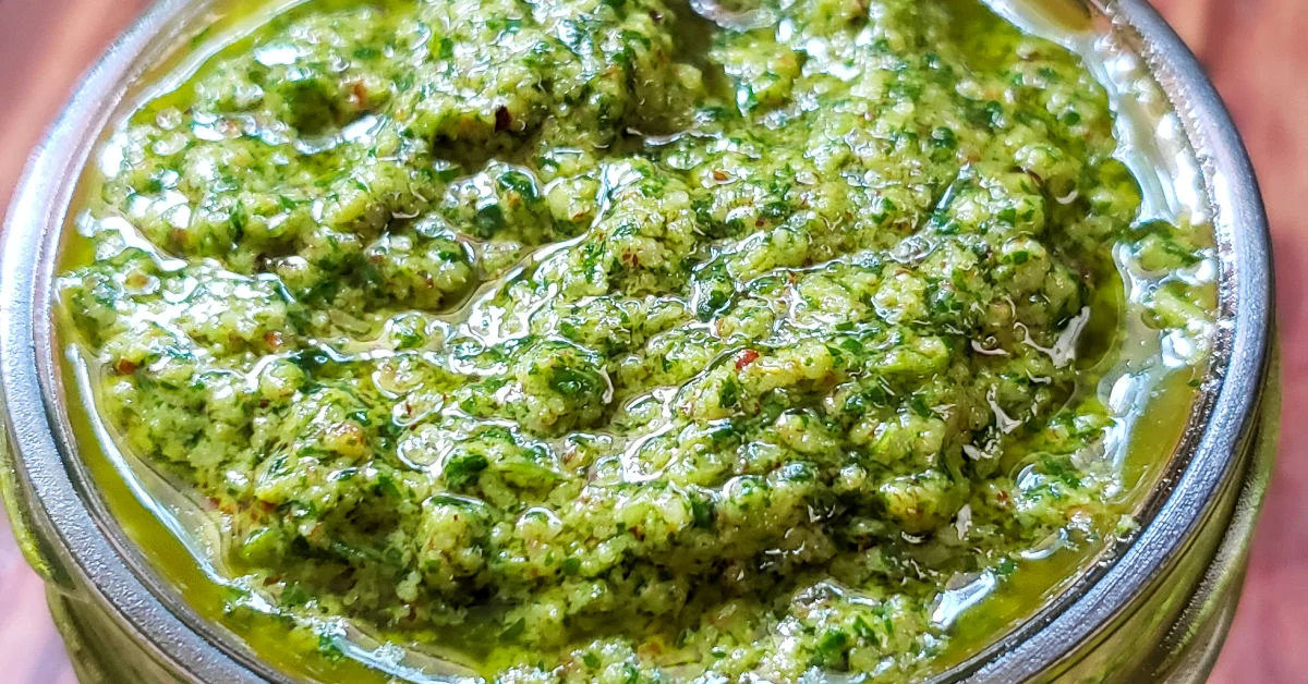 Close up of cilantro pesto in mason jar.