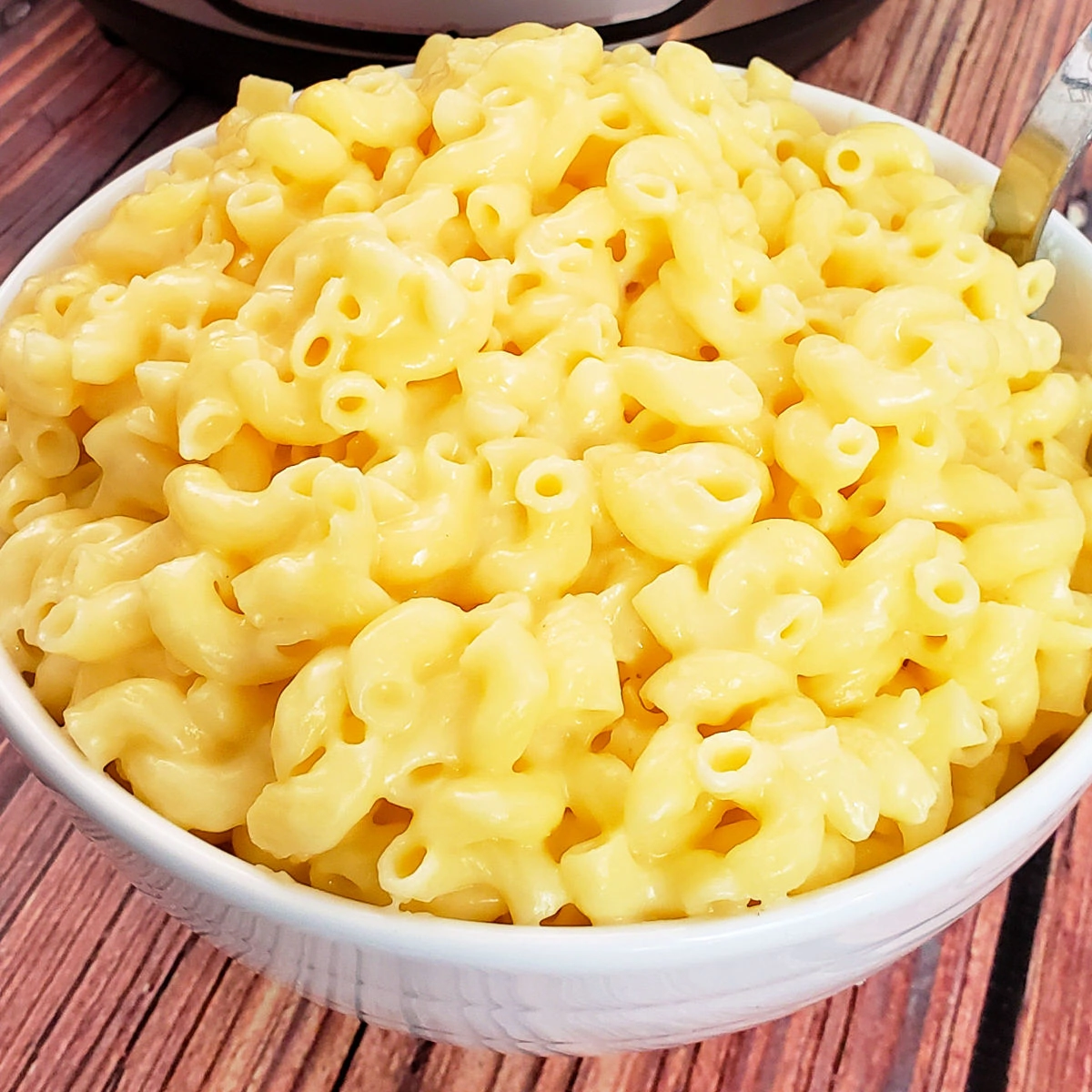 Close up of gluten free mac and cheese in white serving bowl.