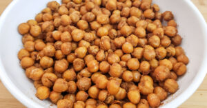 Roasted chickpeas in shallow white serving bowl.