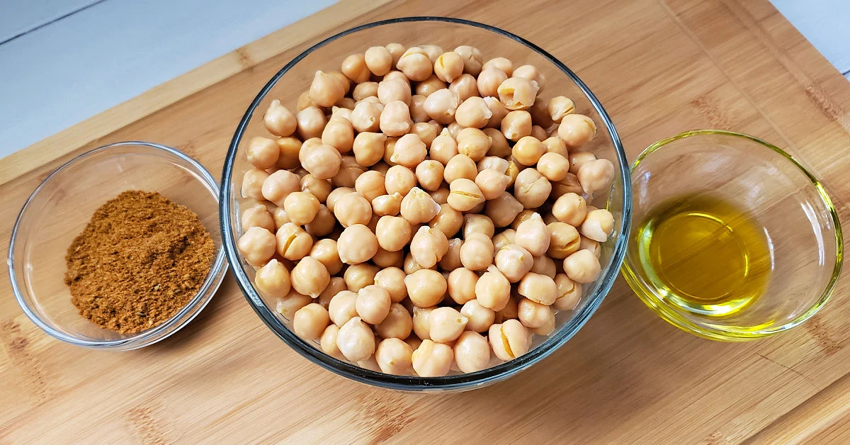 Canned garbanzo beans, extra virgin olive oil and taco seasonings in bowls.