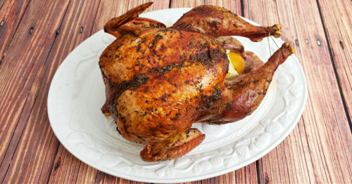 Herb roasted turkey on large serving platter.