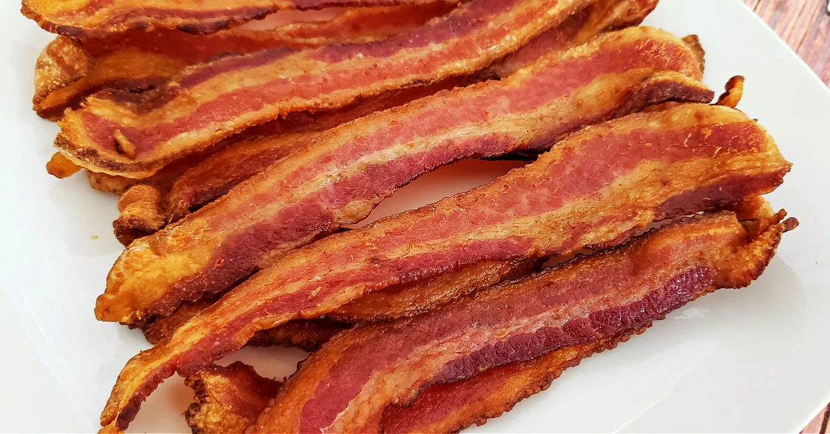 Air fried bacon on white plate.
