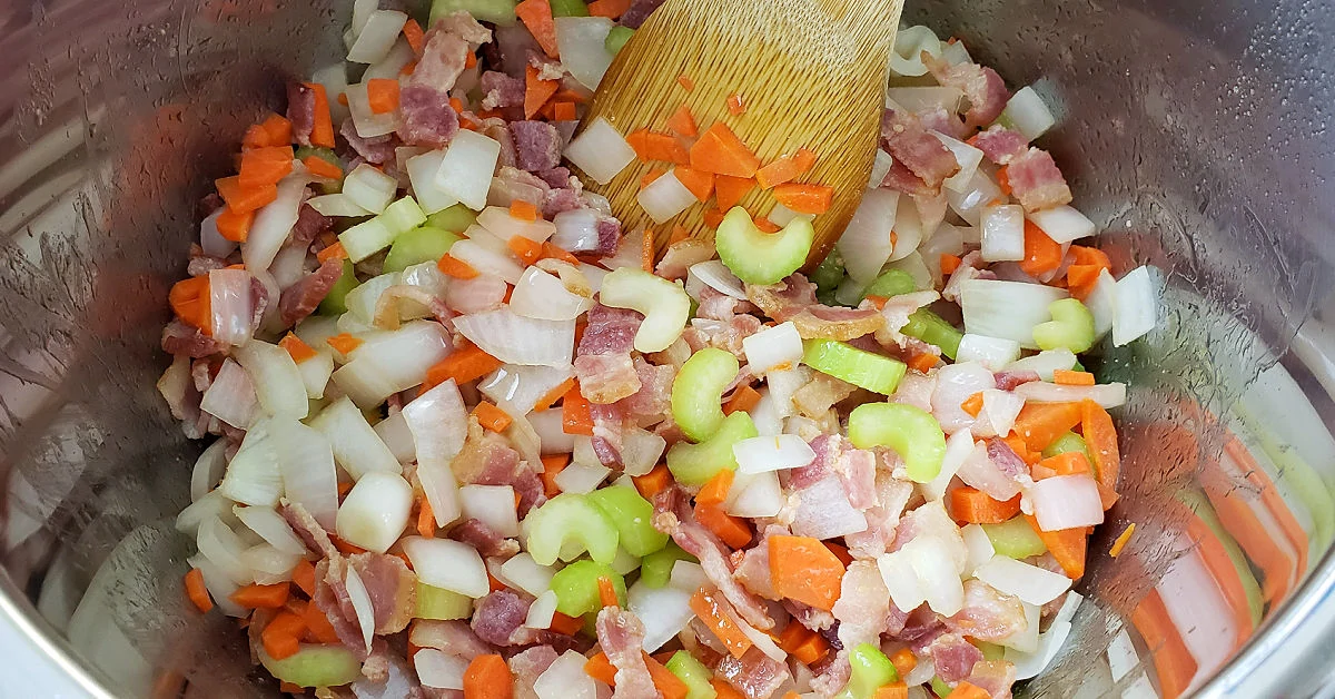 Onion, carrot and celery added to bacon in Instant Pot.