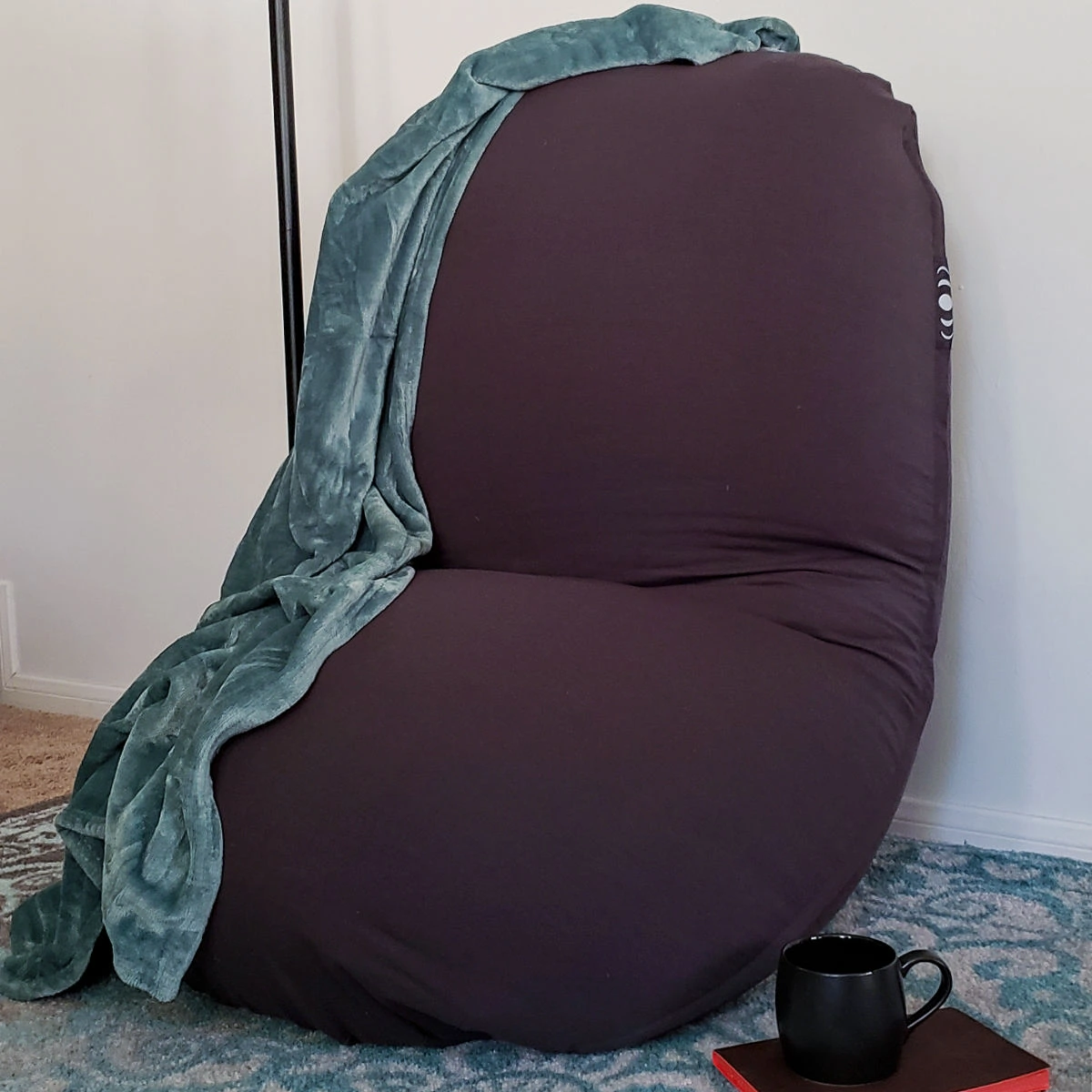 Moon Pod set up as a relaxation zone with blanket, tea and journal.