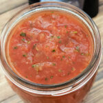 Closeup of Mexican restaurant style salsa in pint jar.