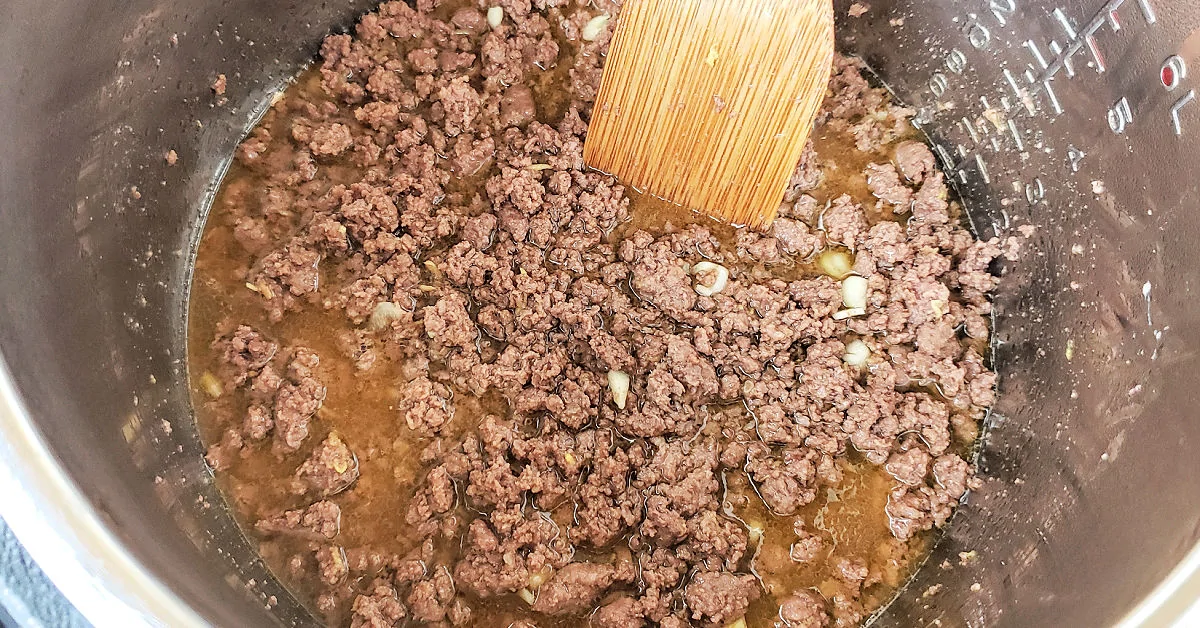 Sauce added to browned ground beef in Instant Pot.