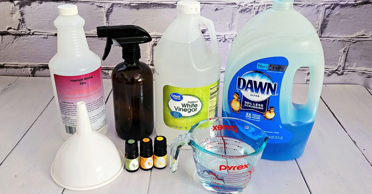 Homemade floor cleaner ingredients, including, rubbing alcohol, dish soap, white vinegar and essential oils.