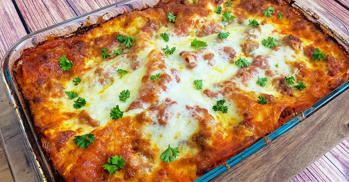Baked gluten free lasagna ready to be served after being garnished with parsley.