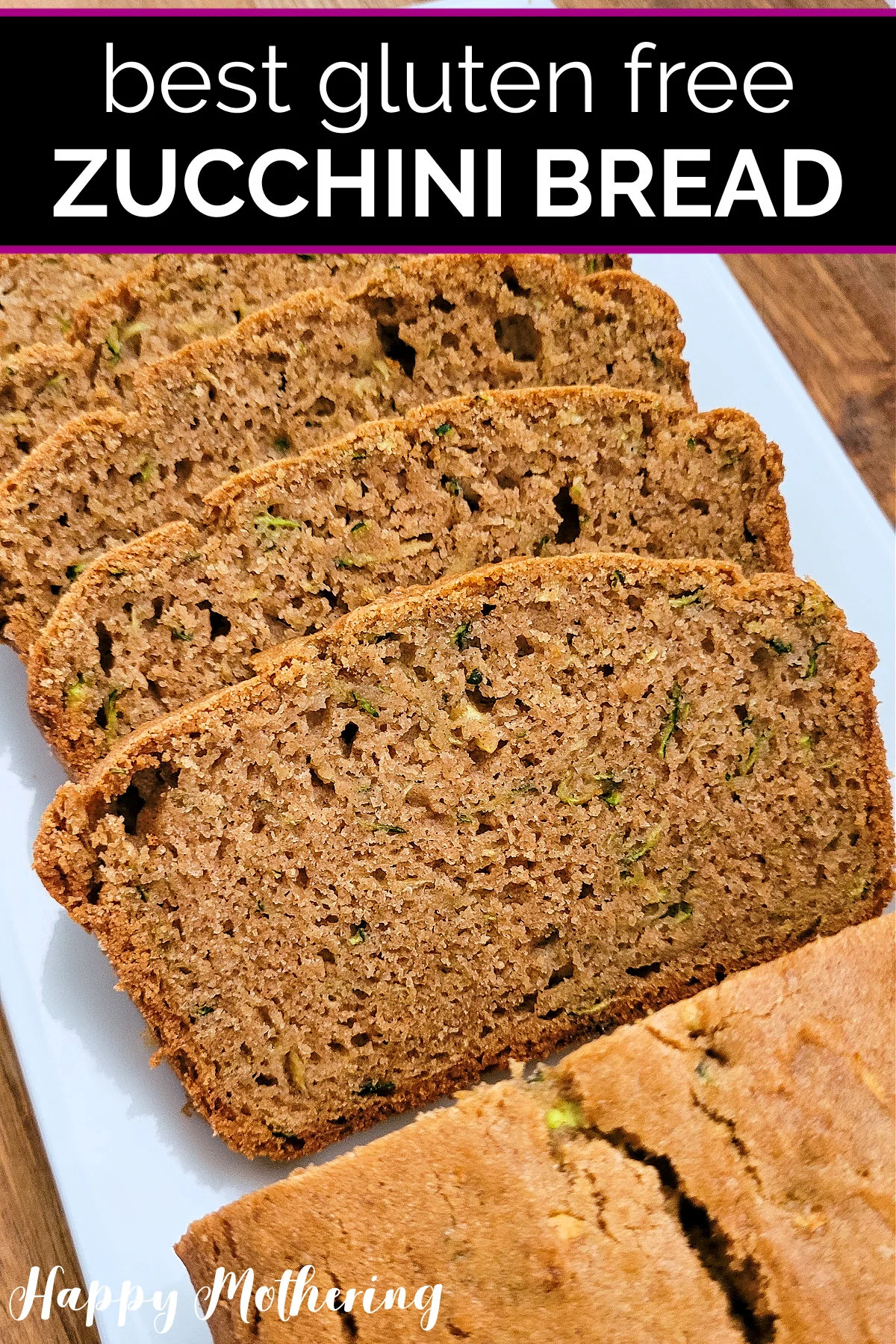 Loaf of gluten free zucchini bread sliced and laid out on a white rectangular serving platter.