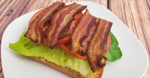 Romaine lettuce, tomato slices and cooked bacon layered over seasoned gluten free bread.