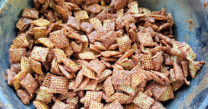 Chex cereal coated in a melted chocolate peanut butter mixture.