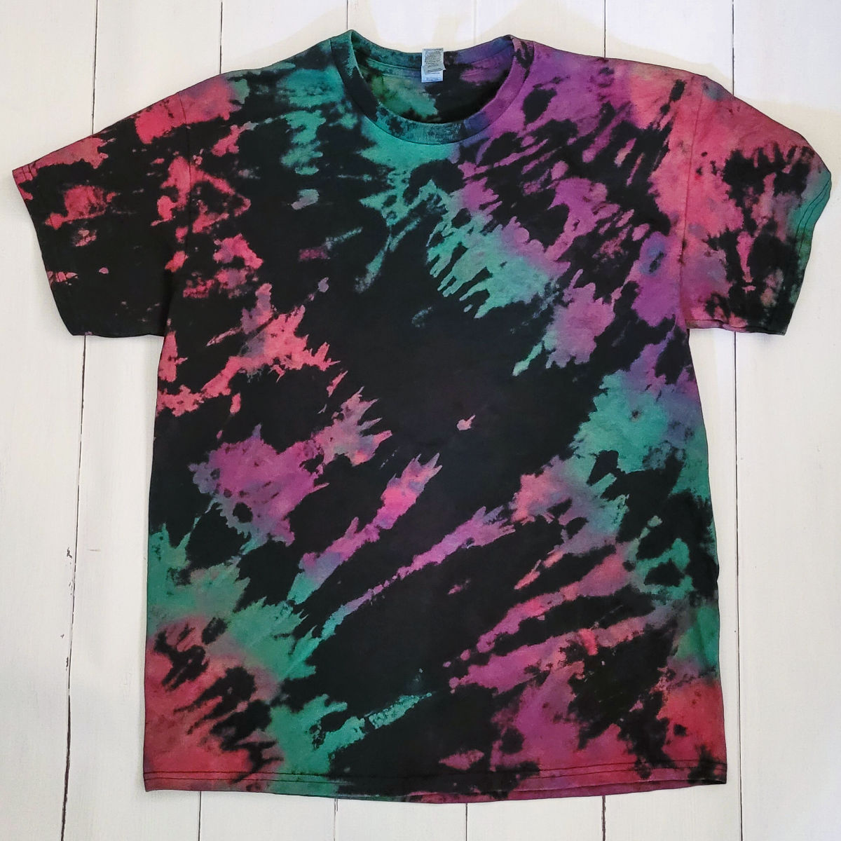 Reverse tie dye shirt in bulleye pattern pulled from the corner of the shirt.