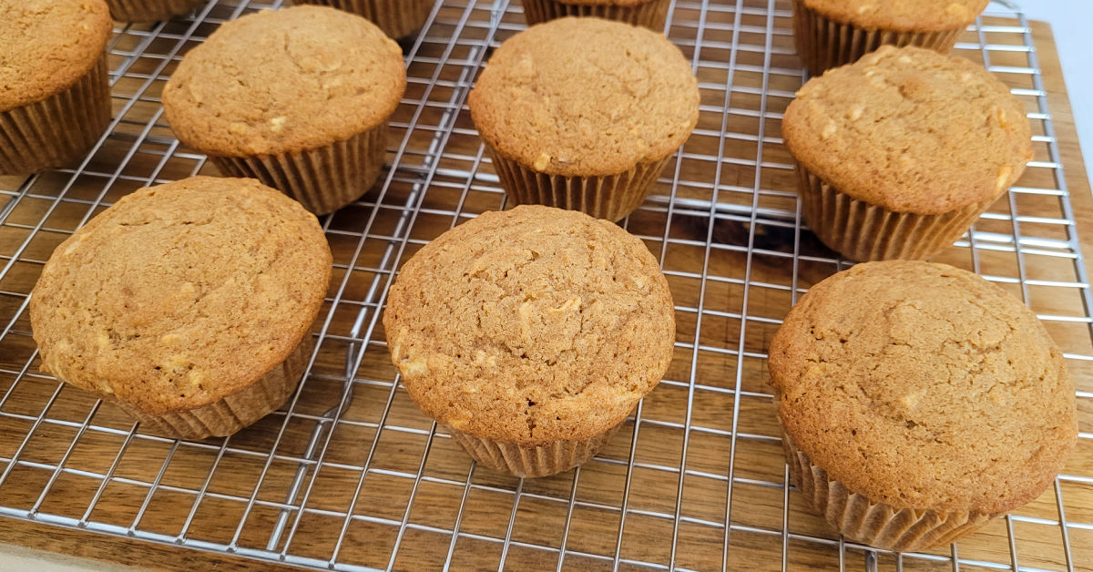 Gluten free apple muffins cooling on a wire rack.
