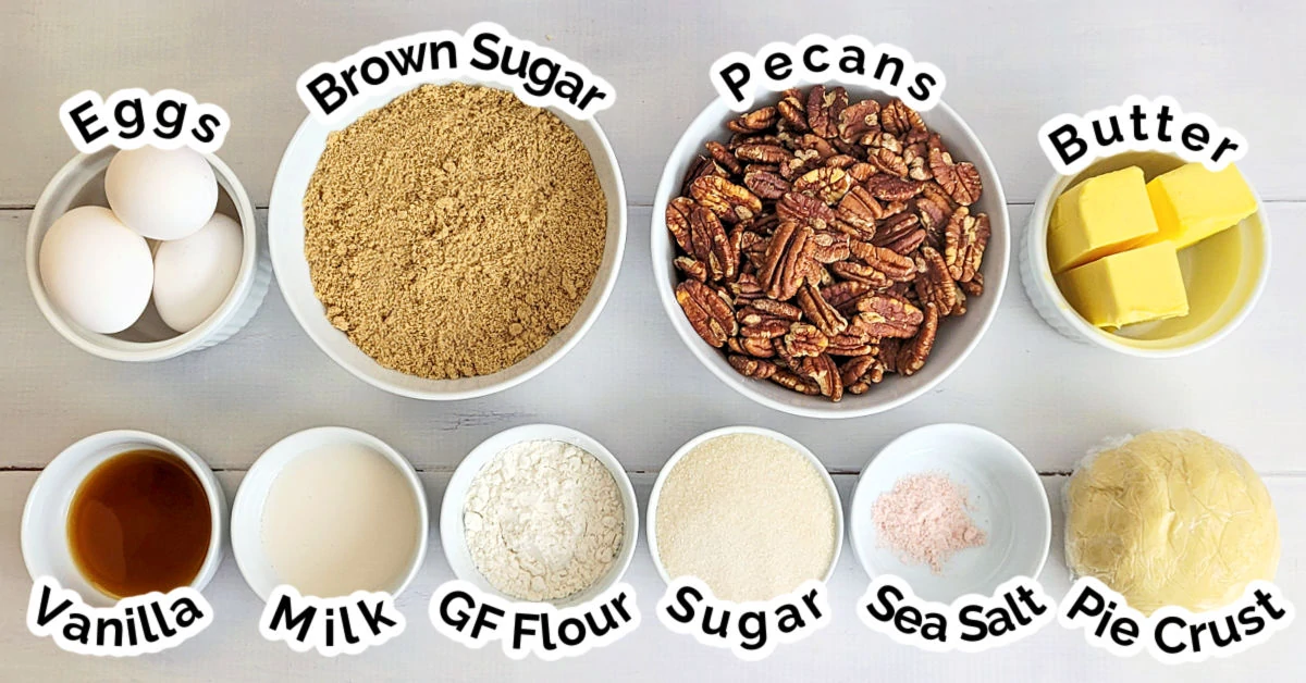 Ingredients for making Gluten Free Pecan Pie measured out into small white bowls and set on a white wood table.