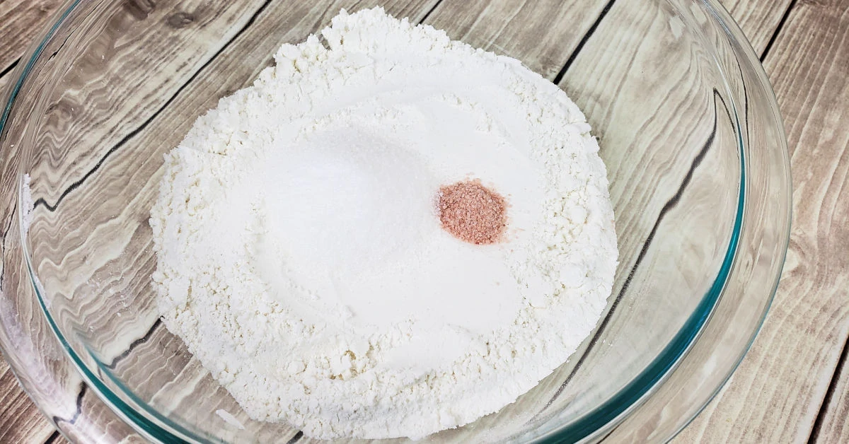 Gluten free flour, sea salt and white sugar in a large glass mixing bowl.