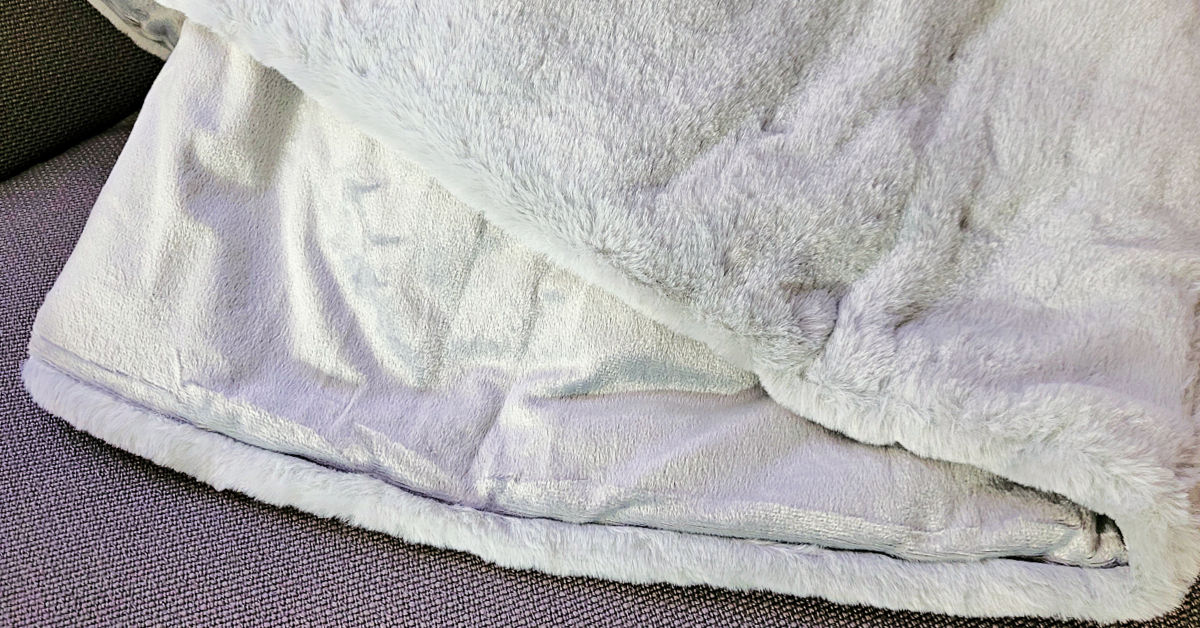 Image showing the two different sides of the Gravity faux rabbit fur weighted blanket.