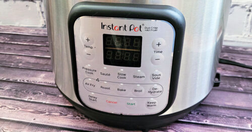 A 6-quart Instant Pot Duo Crisp on a dark wood table at an angle.