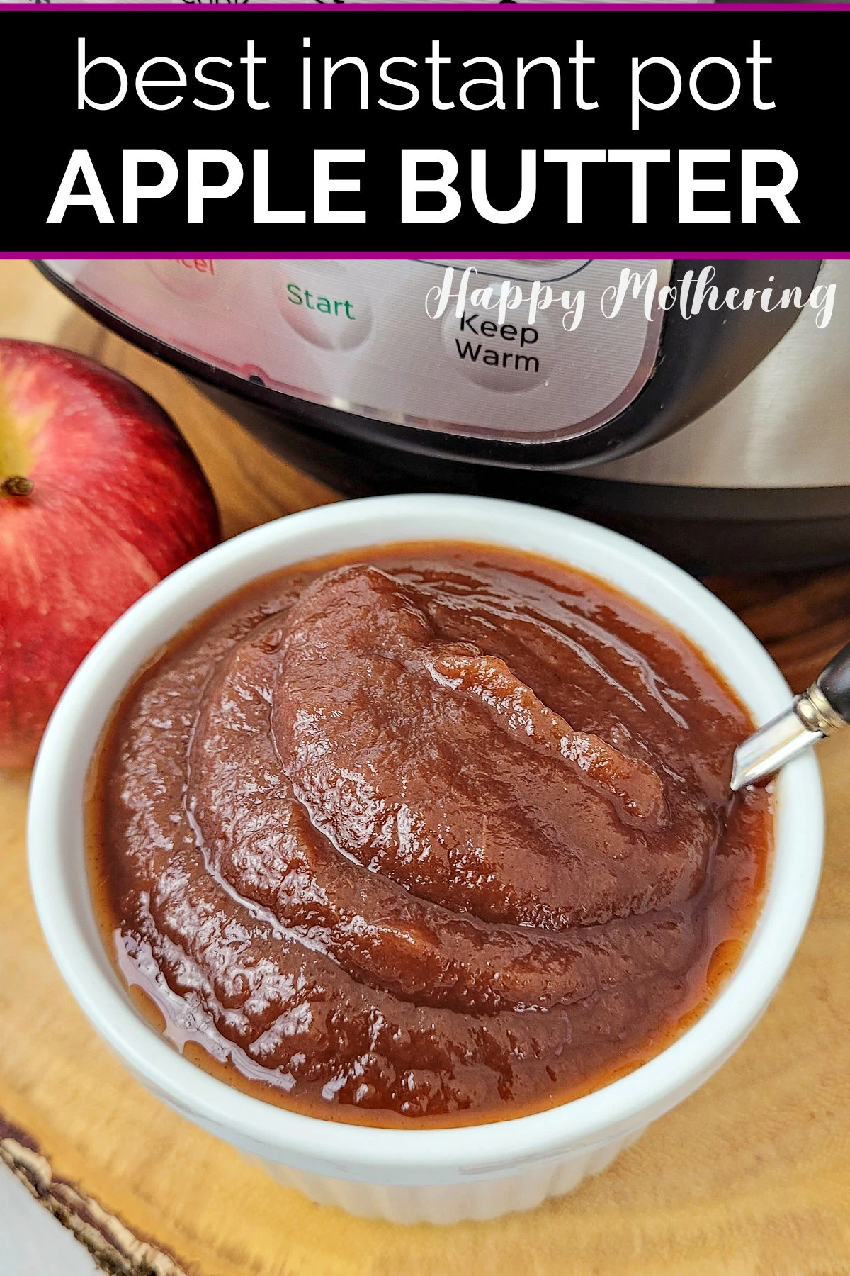 Smooth apple butter in a white bowl with a spoon in front of the Instant Pot it was made in.
