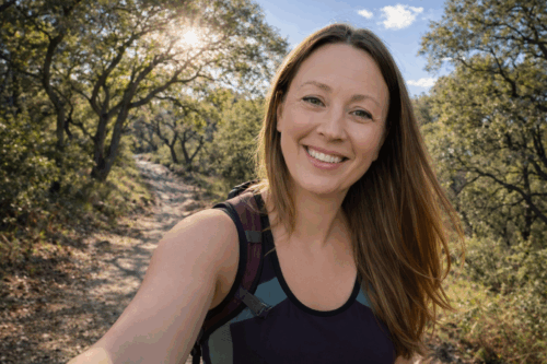 Chrystal hiking on a trail covered in oak trees.